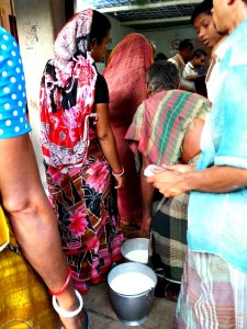 Dairy producers line up with their milk for testing and collection.