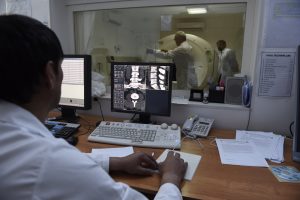 The CT Scanner, donated by CIDA in action at the Regional Diagnostic Unit, Khorog with CT technician, Muqairsho Gadomamadov (L)