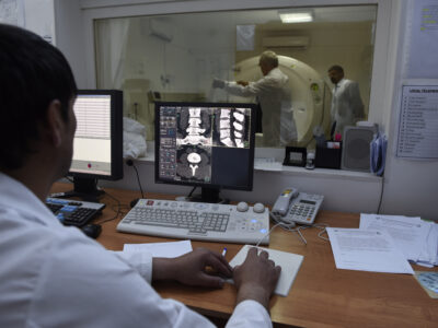 The CT Scanner, donated by CIDA in action at the Regional Diagnostic Unit, Khorog with CT technician, Muqairsho Gadomamadov (L)