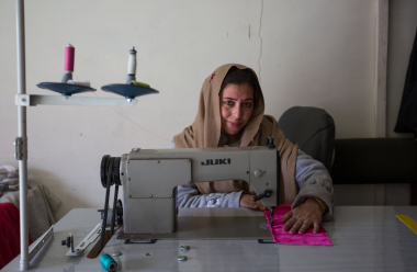 A woman is using a sewing machine.