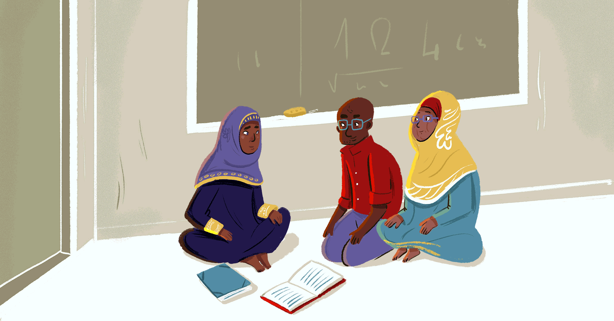 Three teachers are sitting on the floor of a classroom, discussing and sharing ideas.