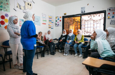 A facilitator addresses a room of young women at the AGENCI centre in Syria.