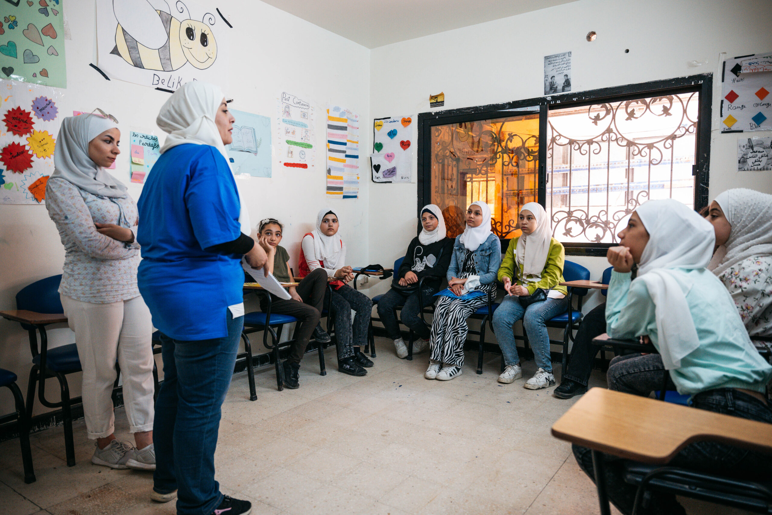 A facilitator addresses a room of young women at the AGENCI centre in Syria.