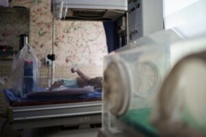 A baby in newborn incubator.
