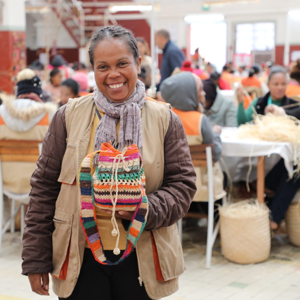 Lalao Tantsoroka showcasing the raffia purse she weaved from the Lalao Tantsoroka showcasing the raffia purse she weaved from the training received through AGECS Project, Antananarivo, Madagascar