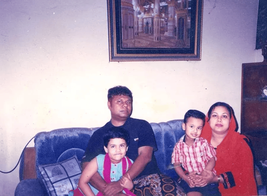 A old family photo, featuring two parents and two children.