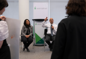 •Fatema Z. Sumar (left), and Khalil Z. Shariff (right), react to project pitches.