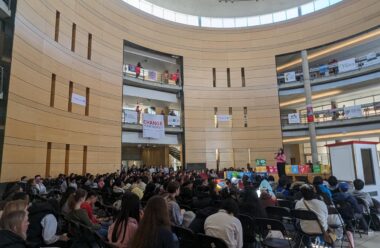 A room of people in a hall.